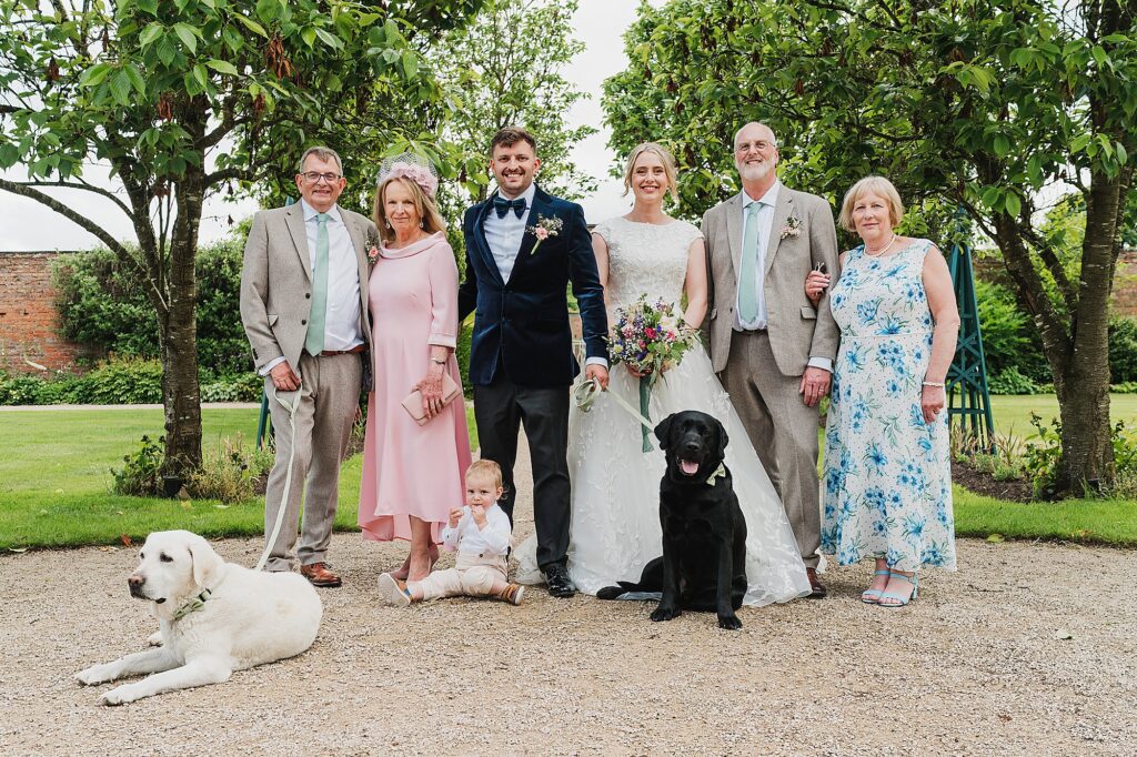 Bride and Groom with both sets of parents and both family dogs at Combermere Abbey // Wedding Photographer Shropshire