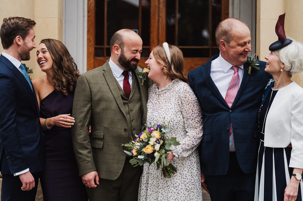 Happy couple with Bride's family all giggling between themselves at Elizabeth Gaskell's House, Manchester // Micro Wedding Manchester