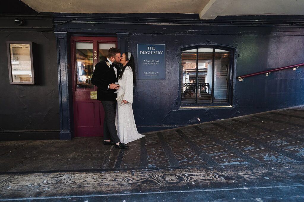 Bride and Groom having a kiss outside the Disguisery in Chester // Chester Wedding Photographer