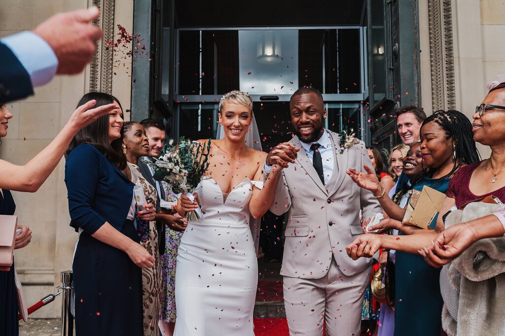 Gorgeous confetti moment outside of St George's Hall with all the colour // Charlotte Giddings Photography
