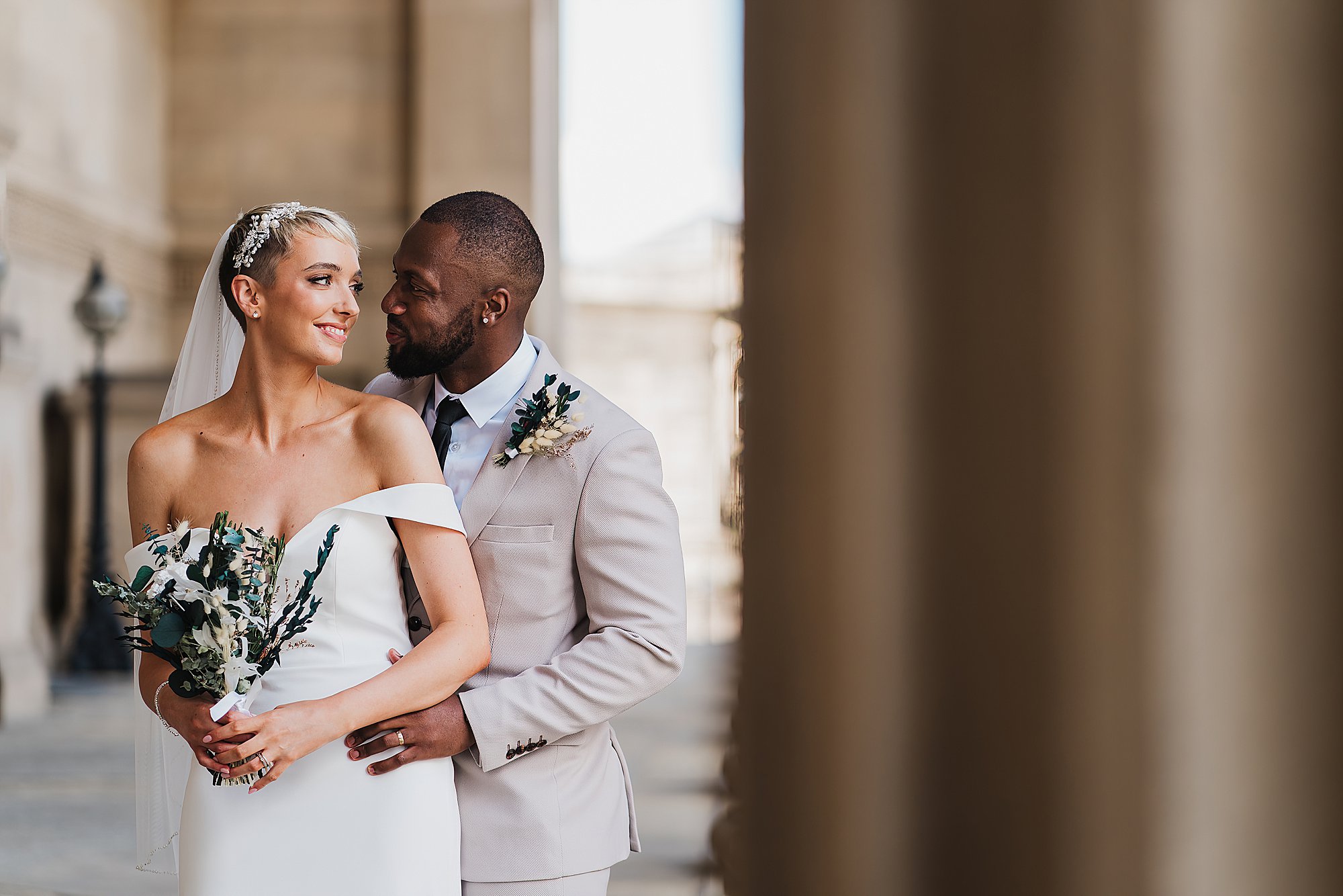 Bride and Groom just married cuddling outside of St. George's Hall, Liverpool
