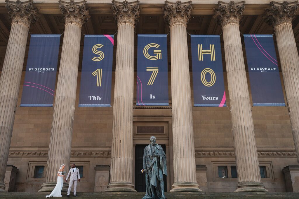 Bride and Groom Walking across the steps at St. George's Hall // Charlotte Giddings Photography

