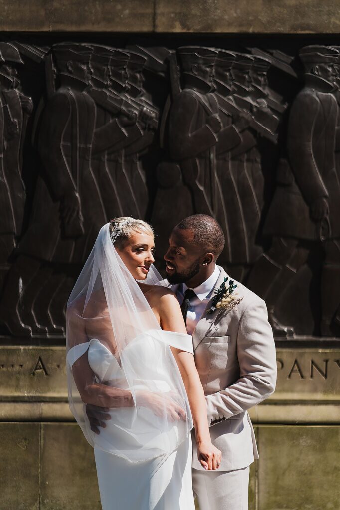 Bride and Groom cuddling in the sunshine outside St George's Hall//Liverpool Wedding Photography
