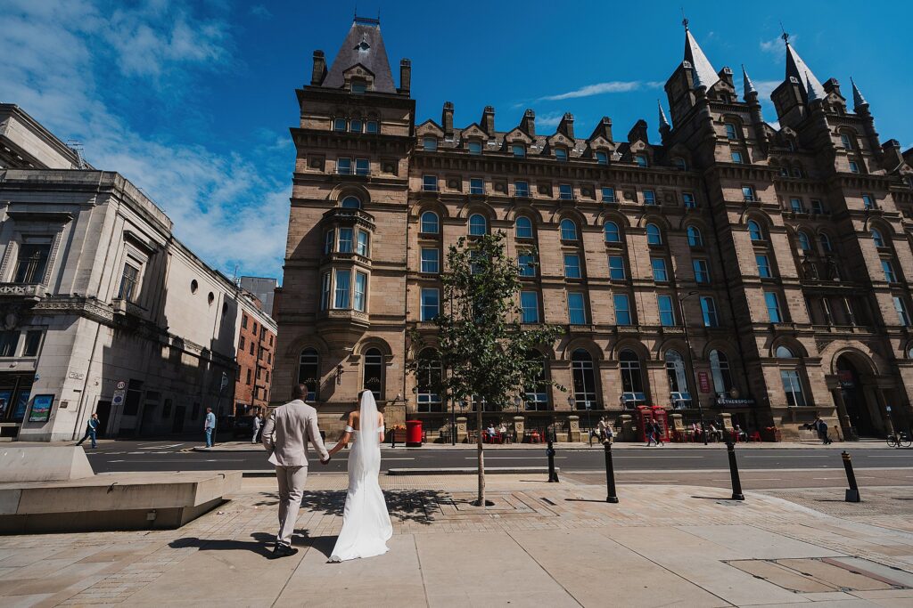 Bride and Groom walking away from St George's Hall and towards their wedding reception with beautiful blue sky
// Charlotte Giddings Photography
