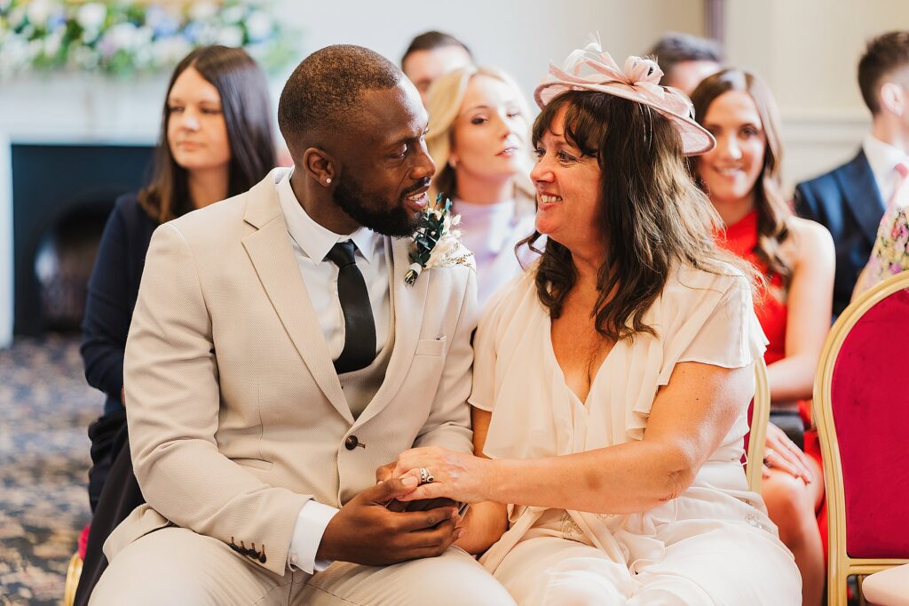 Groom having a moment with the Bride's mum at the front of St. George's Hall Ceremony room//Charlotte Giddings Photography
