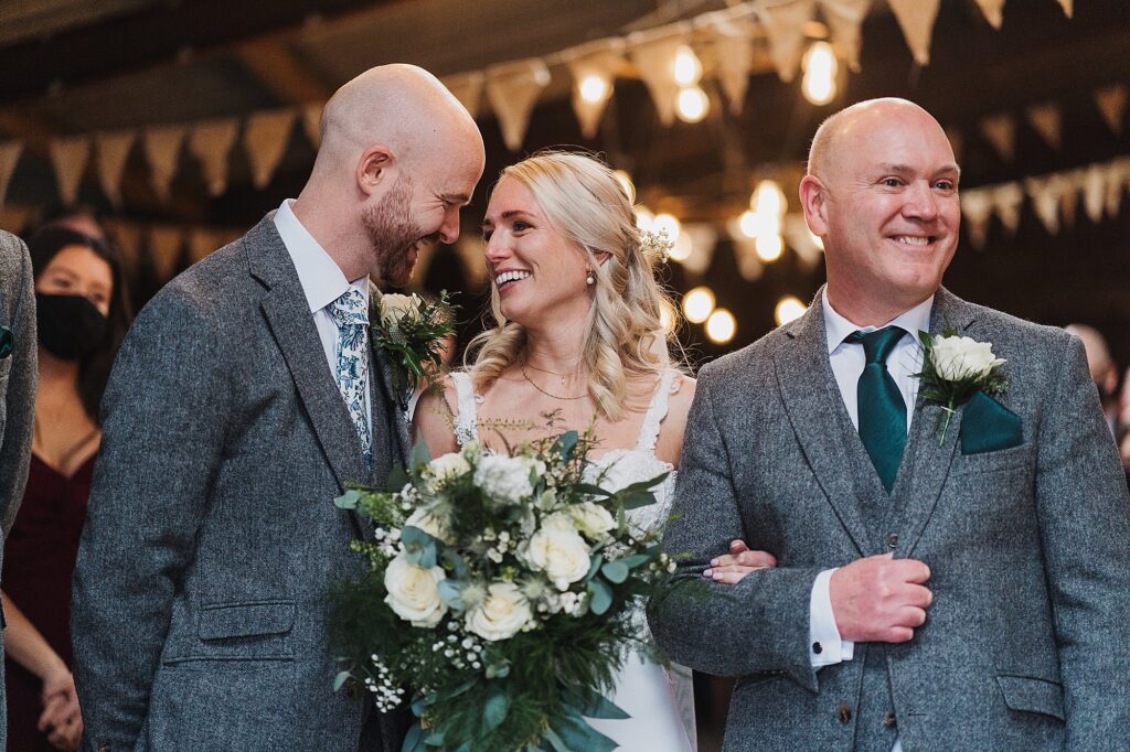 Bride and Groom looking adoringly at one another at the top of the aisle really excited to see one another // Charlotte Giddings Photography