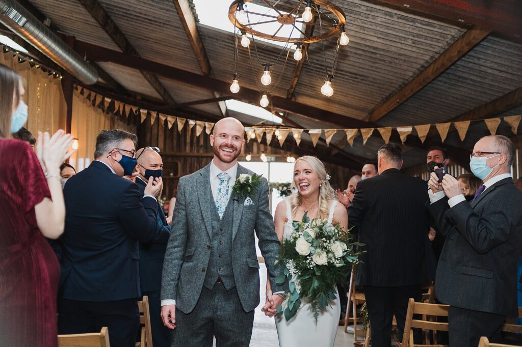 Bride and groom walking down the aisle at Grange Barn Cheshire // Charlotte Giddings Photography