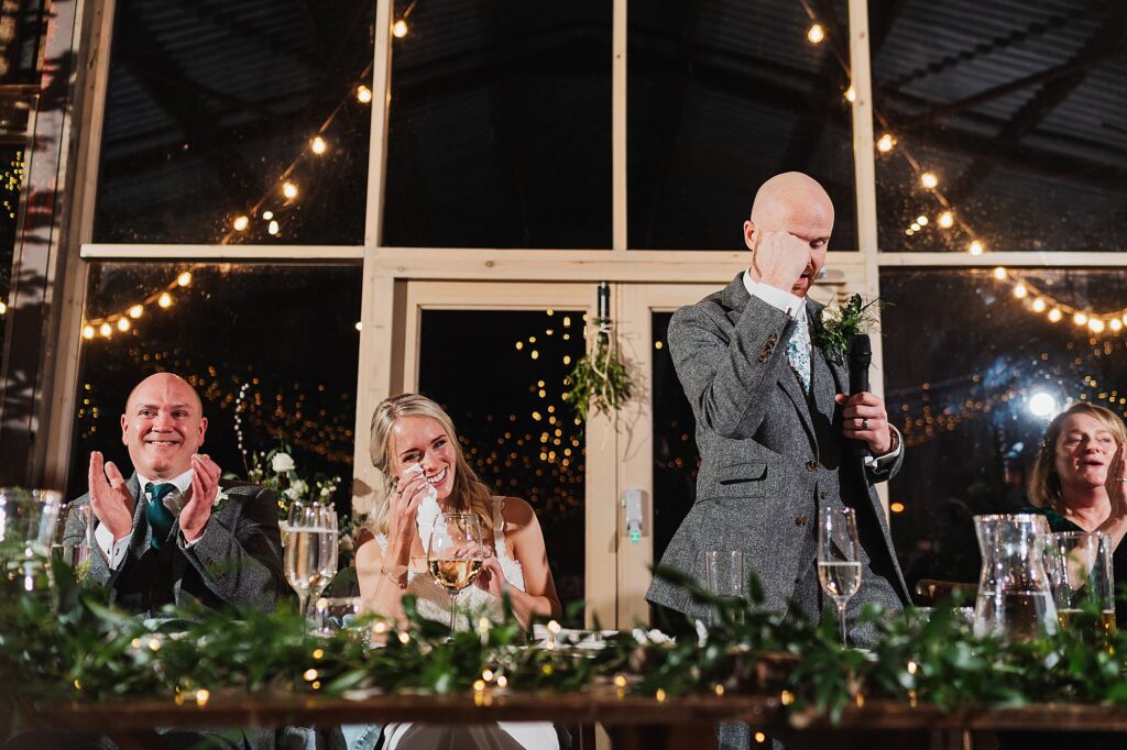 Bride crying during the speeches from the Groom while they are sat at the top table // Charlotte Giddings Photography, Cheshire Wedding Photographer