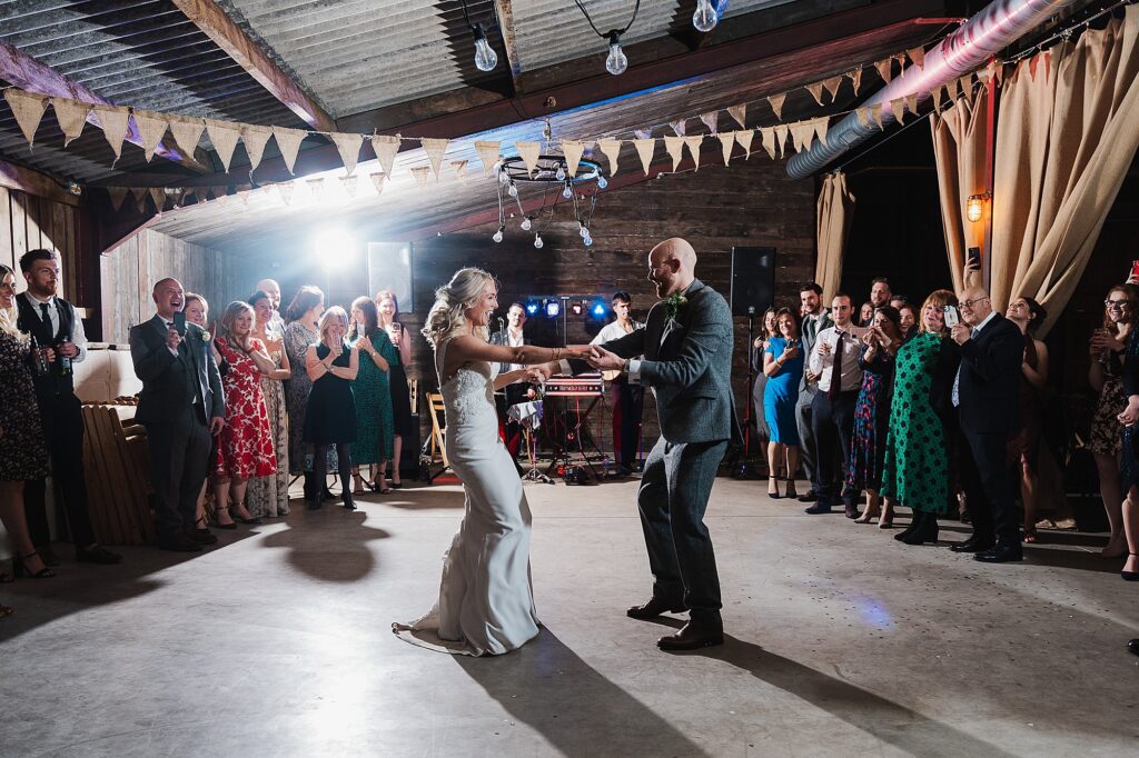 Brie and Groom starting their first dance with the guests surrounding them at Grange Barn Cheshire wedding venue