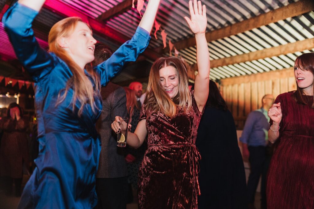 Guests bouncing and jumping around to the music at Grange Barn Cheshire Wedding Venue