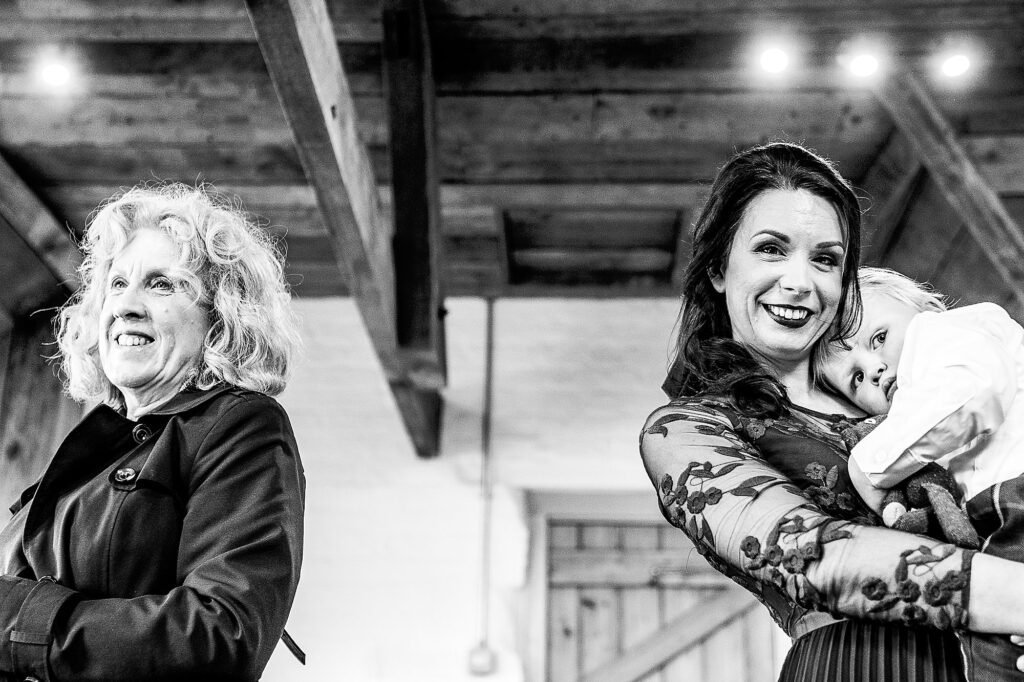 Groom's mum, sister and nephew looking at the bride with big smiles as they watch the bride getting ready at Grange Barn // Cheshire Wedding Photography