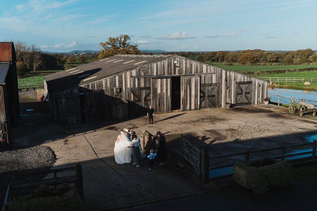 Bride walking over to Grange Barn for the wedding ceremony with her bridal party // Grange Barn Wedding Photographer
