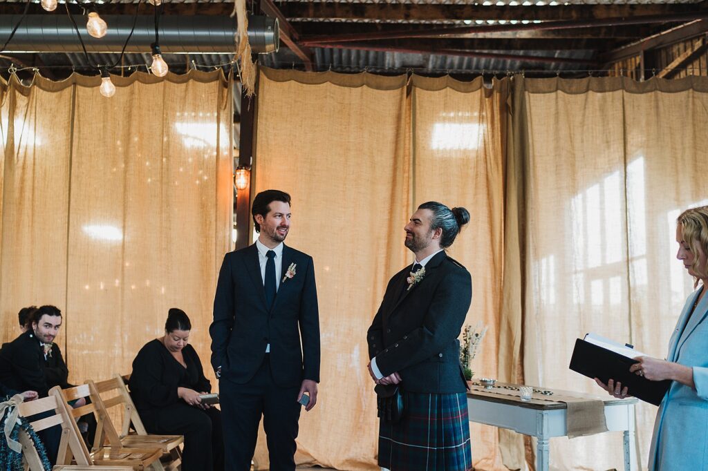 Groom waiting at the top of the aisle with a big smile on his face ready to see the bride // Cheshire Wedding Photography