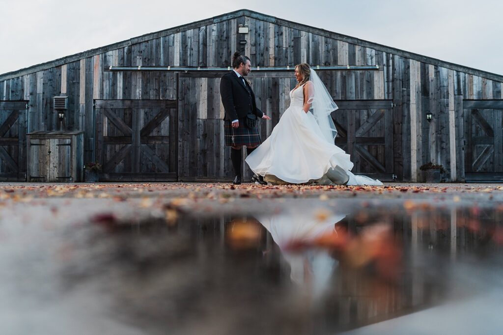 Bride and groom dancing around out side of Grange Barns, Cheshire Wedding Venue // Charlotte Giddings Photography