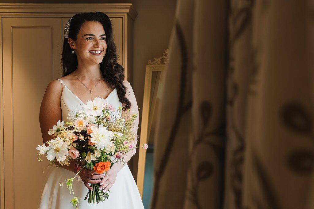 Bride looking so incredibly excited, dressed and ready to go to the ceremony at Hencote Estate