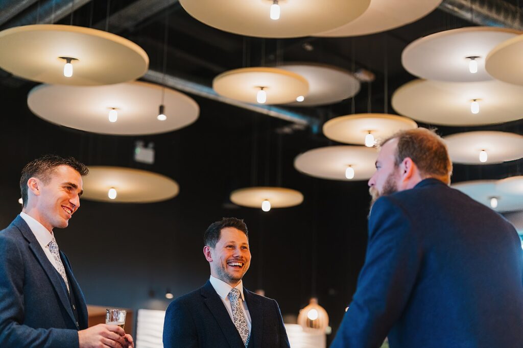 The Groom giggling with wedding guests in the Hencote Wedding Reception // Charlotte Giddings Photography