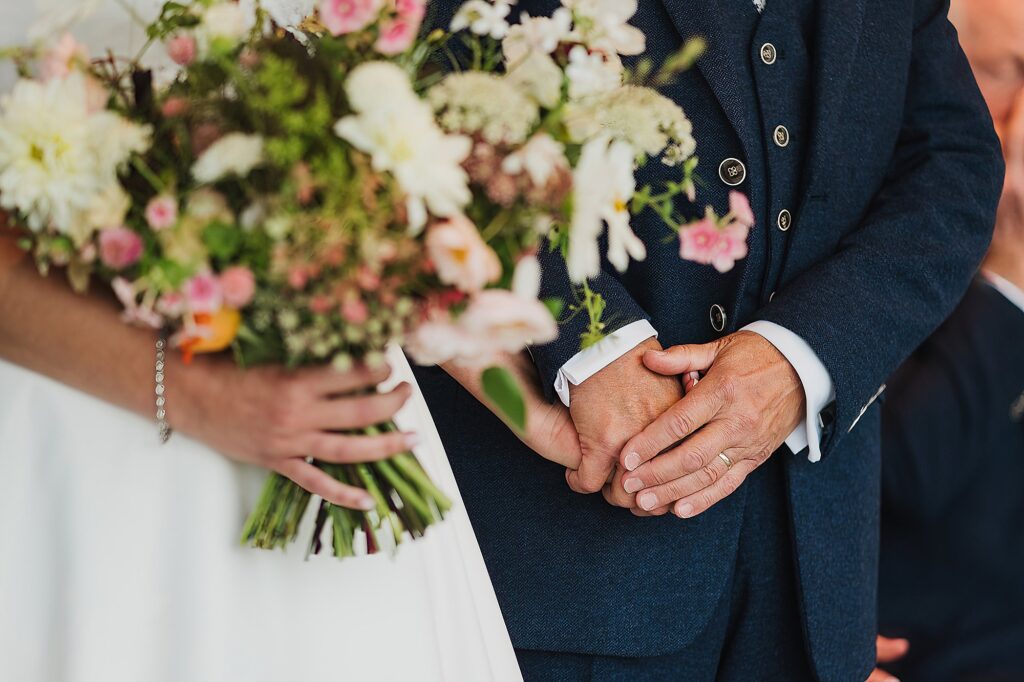 Bride and Bride's dad holding hands at the top of the aisle // Charlotte Giddings Photography