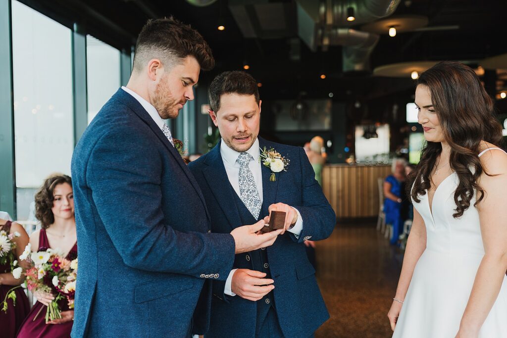 Groom taking the bride's ring out of the box from the Best Man // Hencote Wedding Photographer