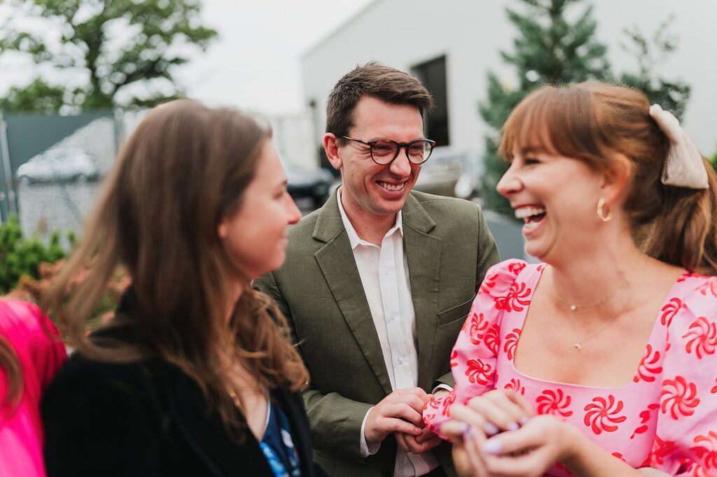Guests having a right good giggle between themselves at Hencote Estate as they wait for the couple and throw confetti