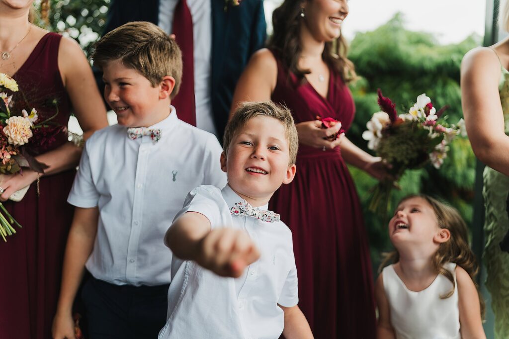 Children ready to throw confetti at the bride and groom looking very excited // Charlotte Giddings Photographer