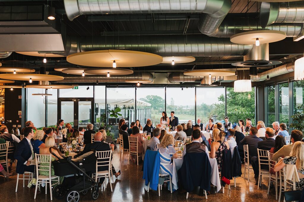 All the wedding guests listening to the bride and groom as they do their speech at Hencote // Wedding Photographer Shropshire