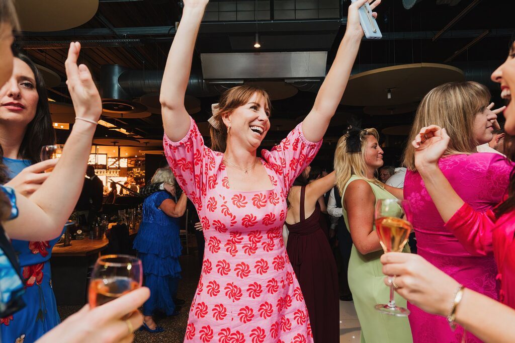 Guest dancing with arms in the air having a super time with the live music // Charlotte Giddings Photographer