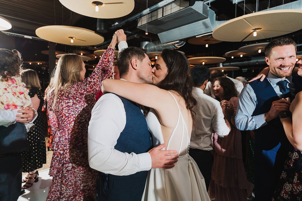 Bride and Groom kissing on the dancefloor amongst their guests // Shrewsbury Wedding Photographer
