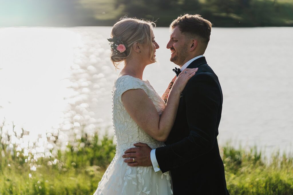 Bride and Groom in beautiful golden hour light by the lake at Combermere Abbey, Whitchurch, Shropshire