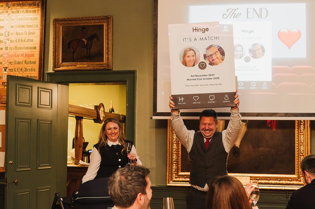 Best man and woman doing their speech at The Swan, Tarporley, holding up a card from hinge.com with the couple being a match!