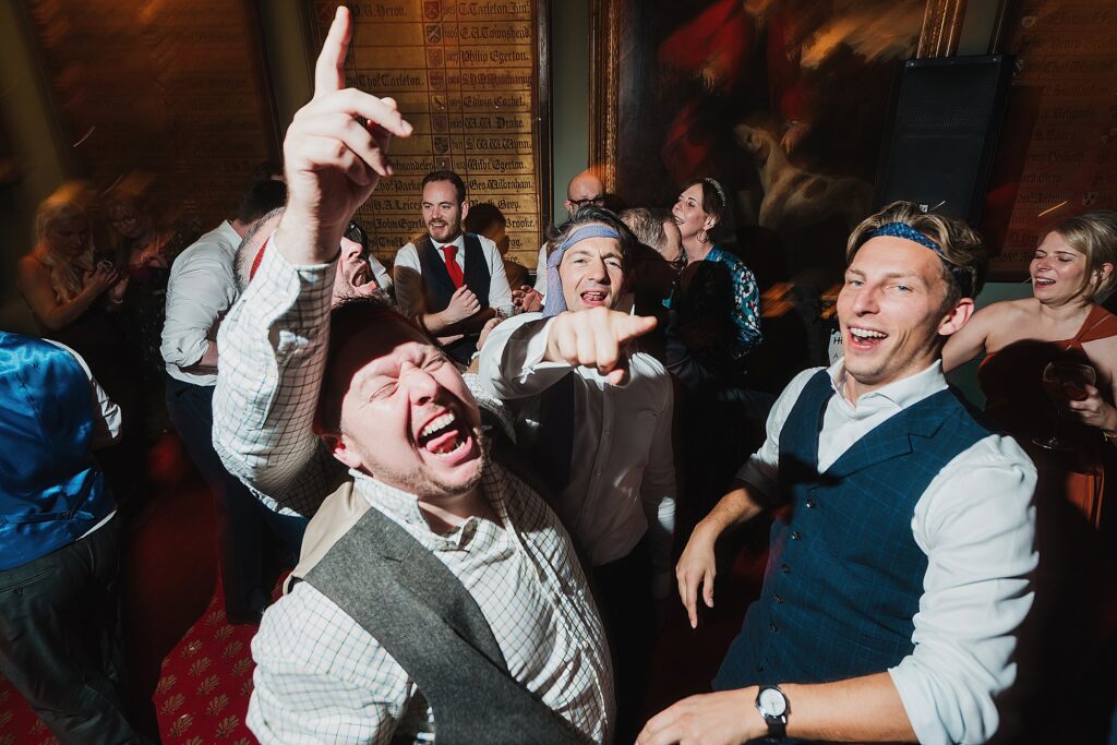Guests dancing with ties around their heads having a good old time at The Swan, Tarporley, Cheshire