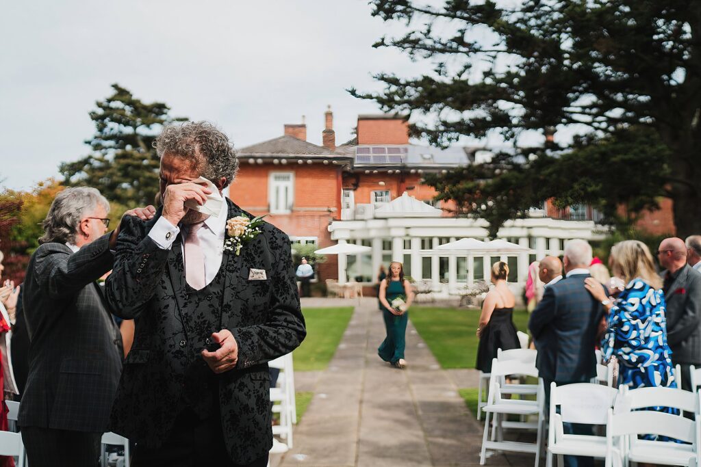 Groom crying at the top of the aisle as he waits for the bride to arrive //. Staffordshire Wedding Photographer