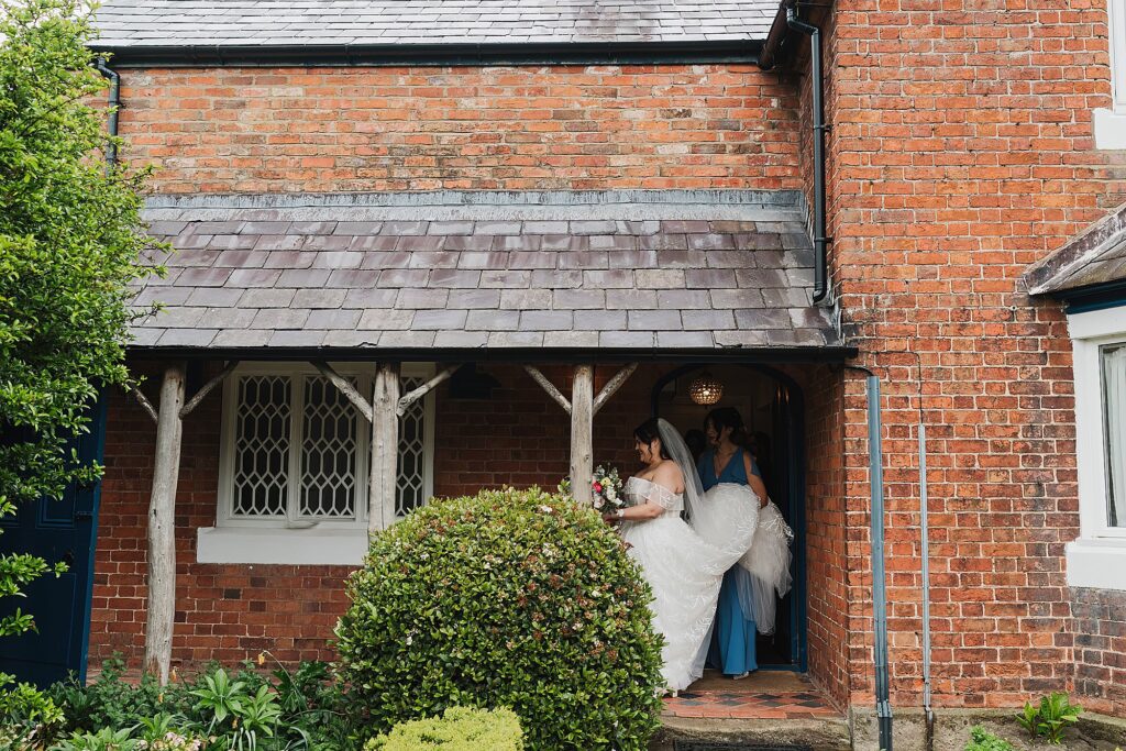 Bride leaving the Keeper's Cottage to walk up to the Glasshouse ceremony // Shropshire Wedding Photography