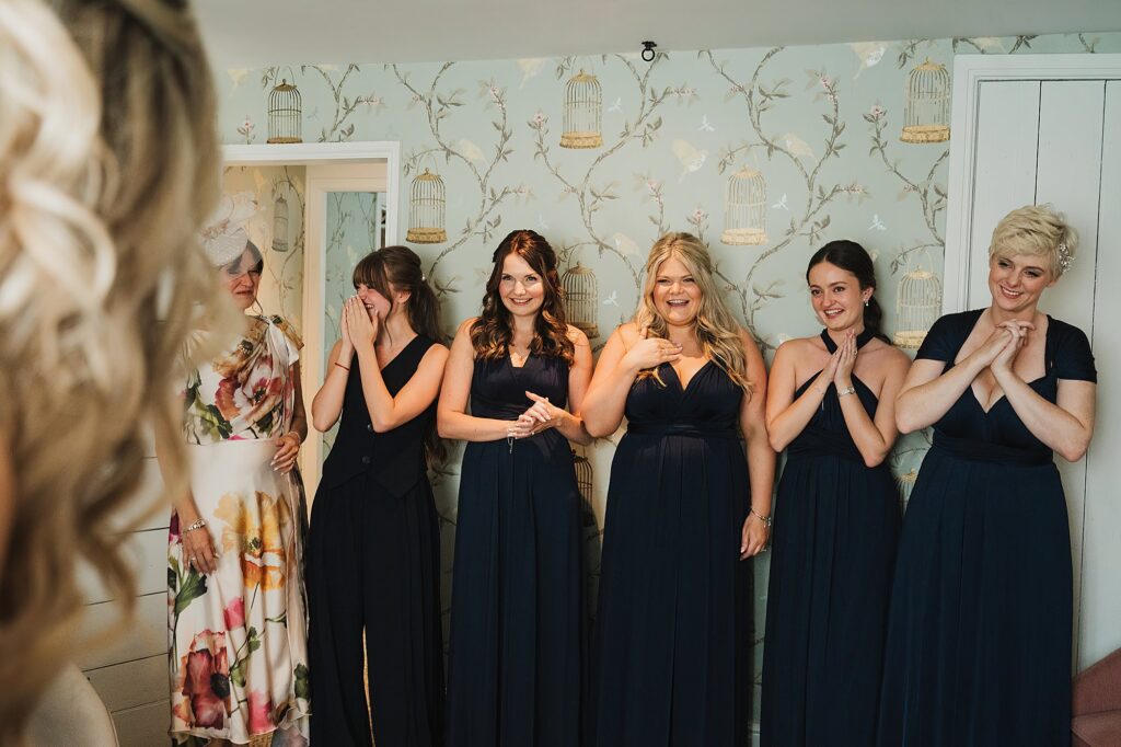 Bridesmaids looking at the bride fully ready to get married // Charlotte Giddings Photography