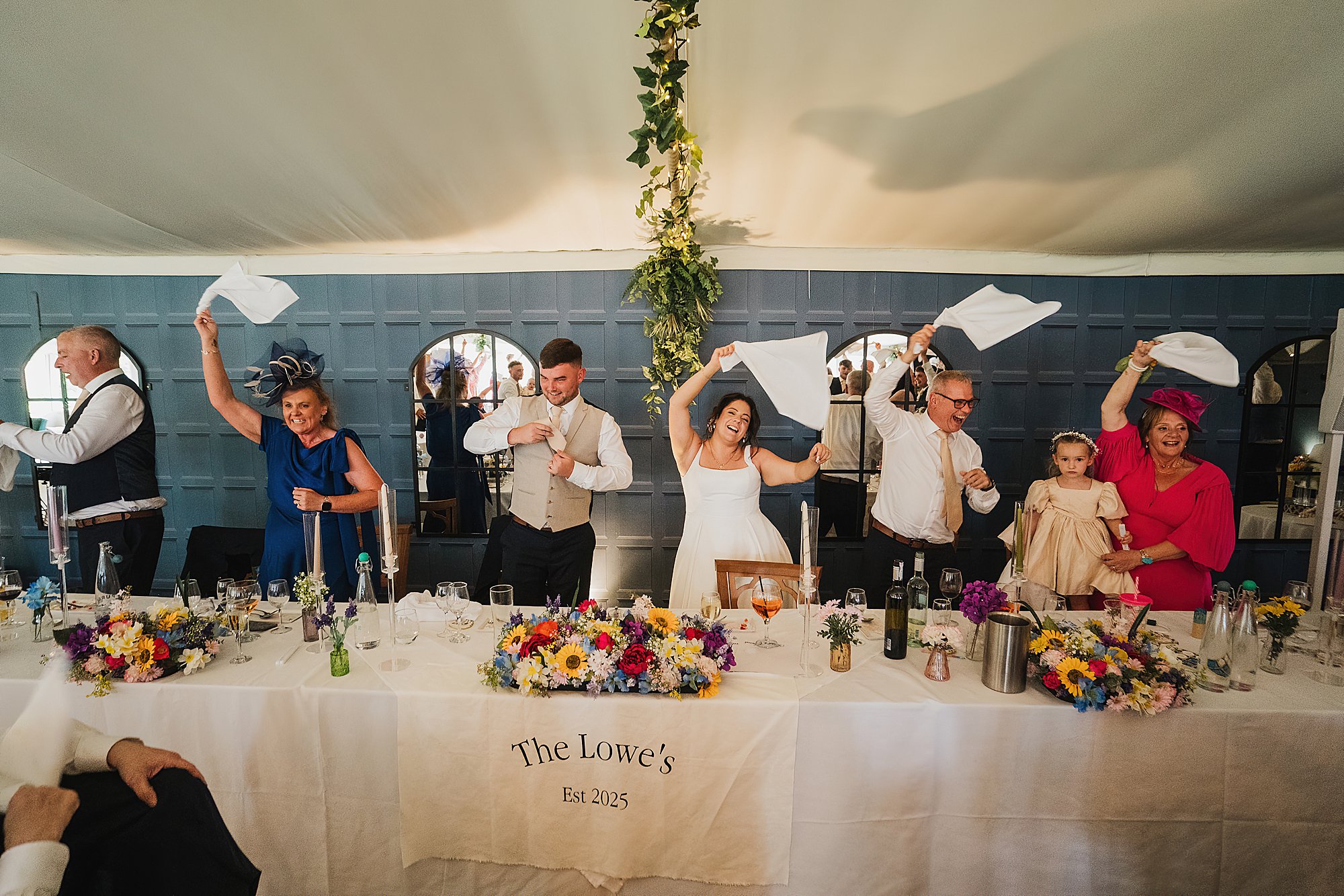 dancing and napkin swinging on the top table with entertainment from the singing waiters / Pavilion Combermere Abbey